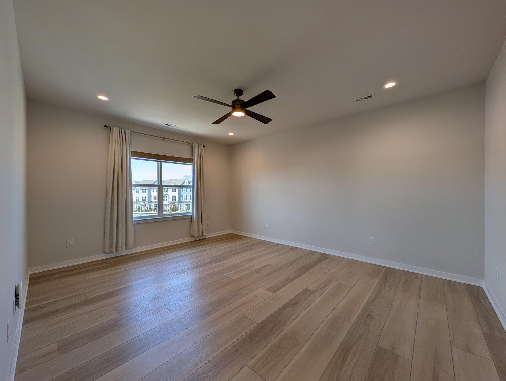 141 South Lore's Landing Road Middletown, DE 19709 - Photo 25 of 60 an empty room with wooden floor and windows