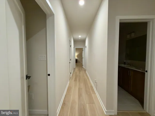 a view of a hallway with wooden floor and staircase