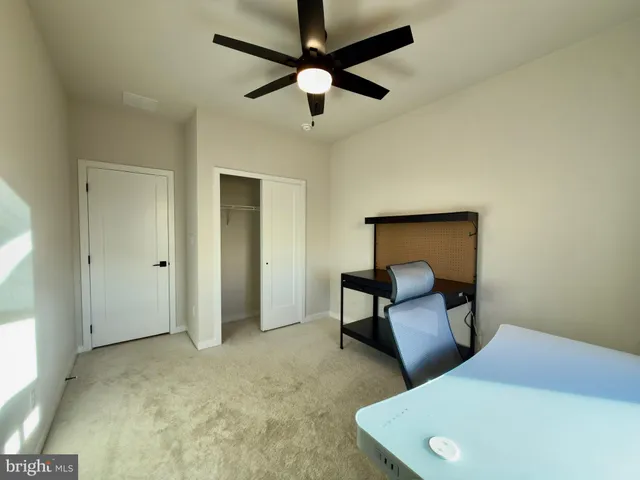 a bedroom with a bed and a chair