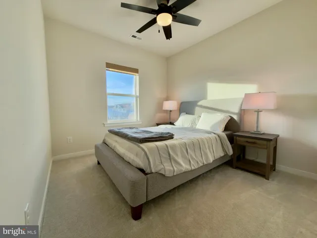 a bedroom with a bed and lamp