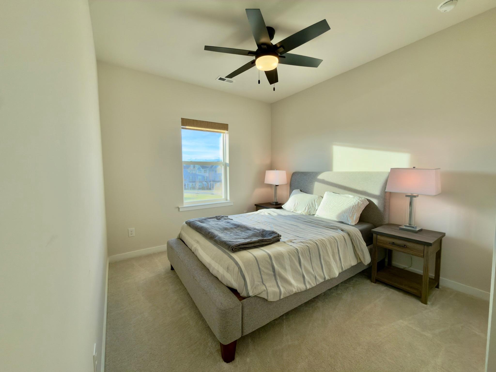 141 South Lore's Landing Road Middletown, DE 19709 - Photo 44 of 60 a bedroom with a bed chandelier and a window