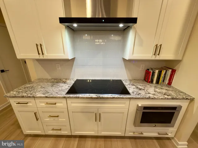 a stove top oven sitting inside of a kitchen