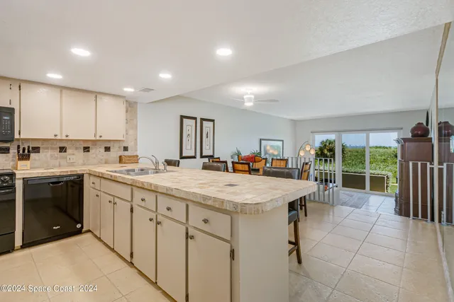a large kitchen with kitchen island a sink stainless steel appliances and cabinets