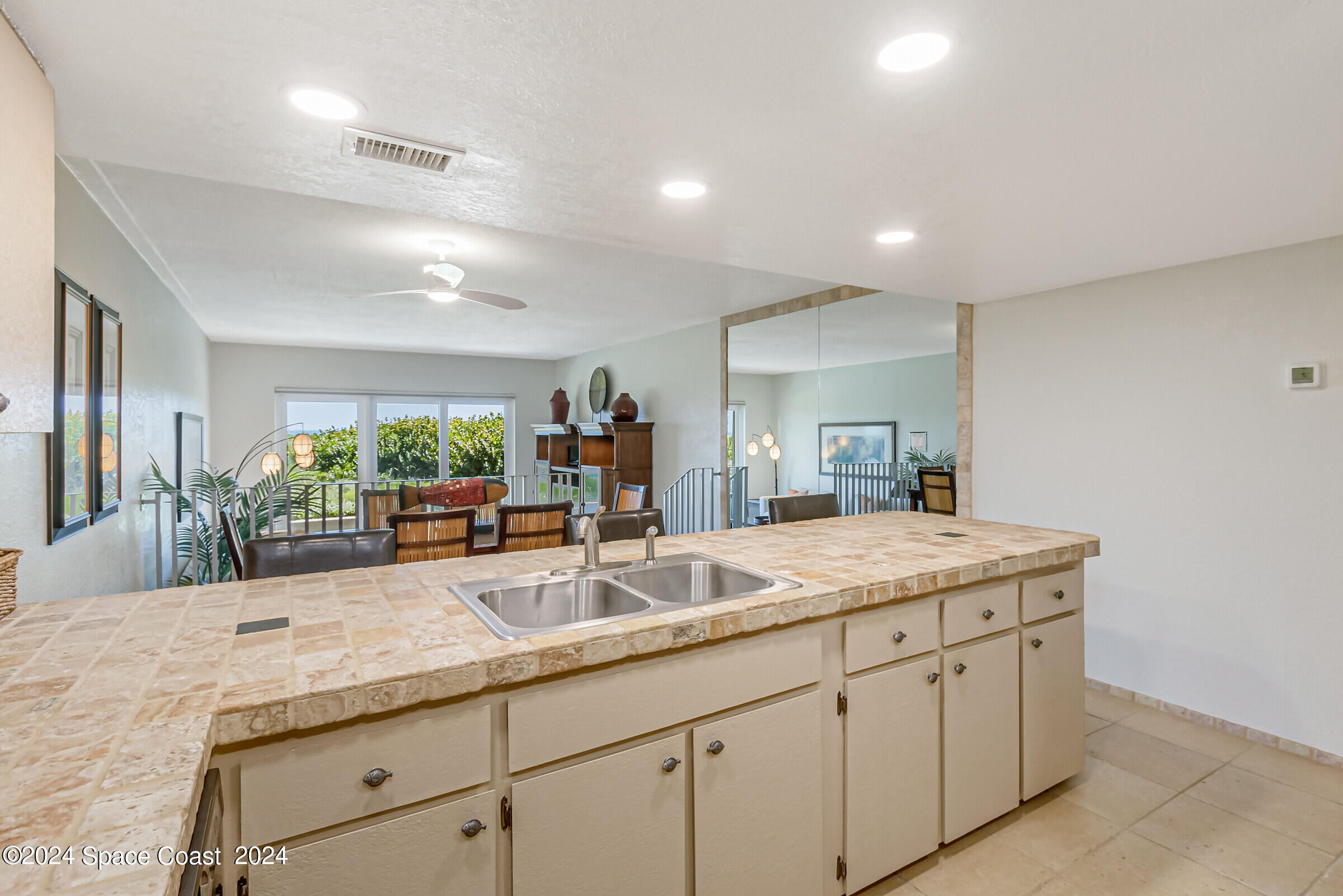 5050 Ocean Beach Boulevard Cocoa Beach, FL 32931 - Photo 13 of 33 a bathroom with a granite countertop sink and a mirror