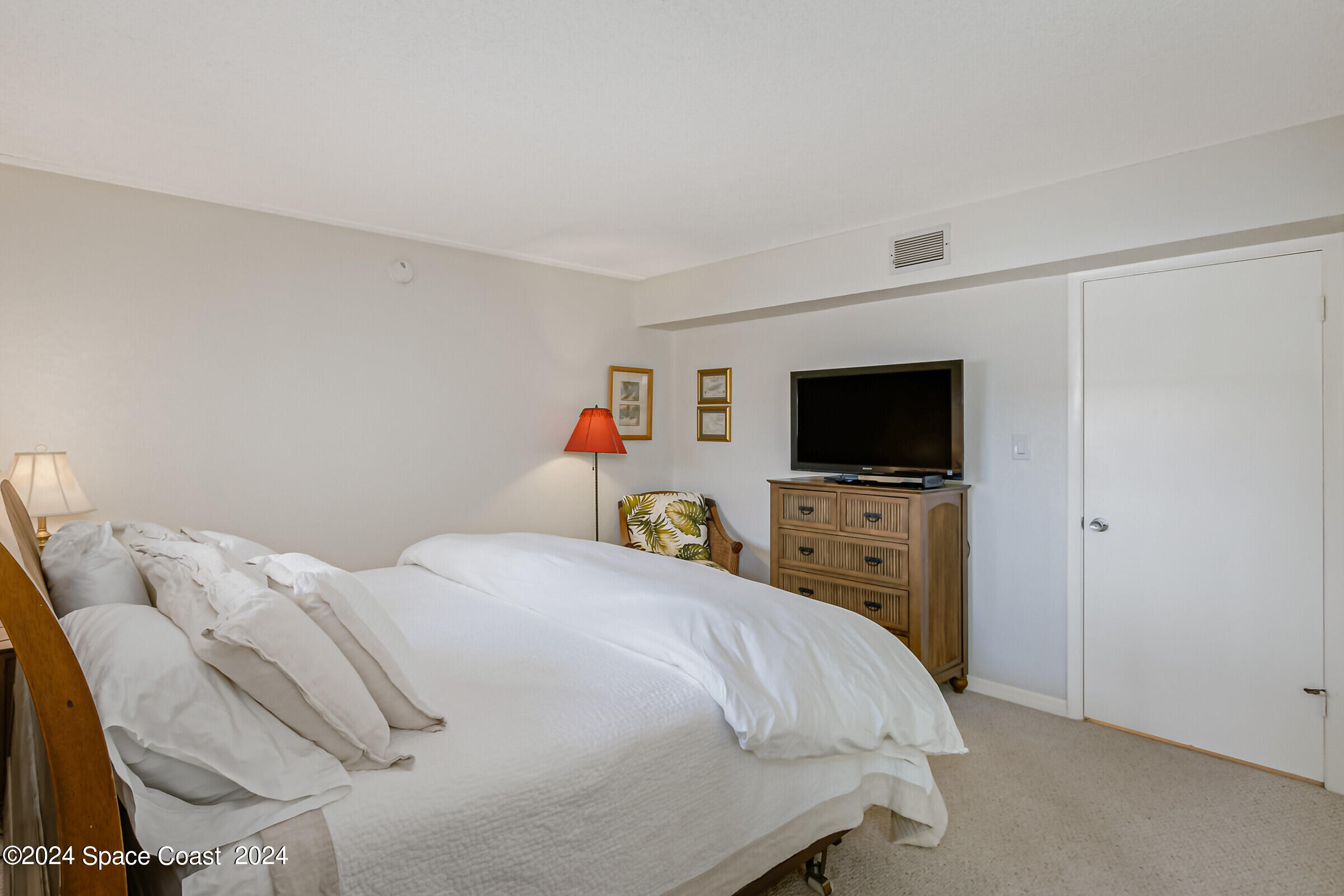 5050 Ocean Beach Boulevard Cocoa Beach, FL 32931 - Photo 22 of 33 a bedroom with a bed and a flat screen tv