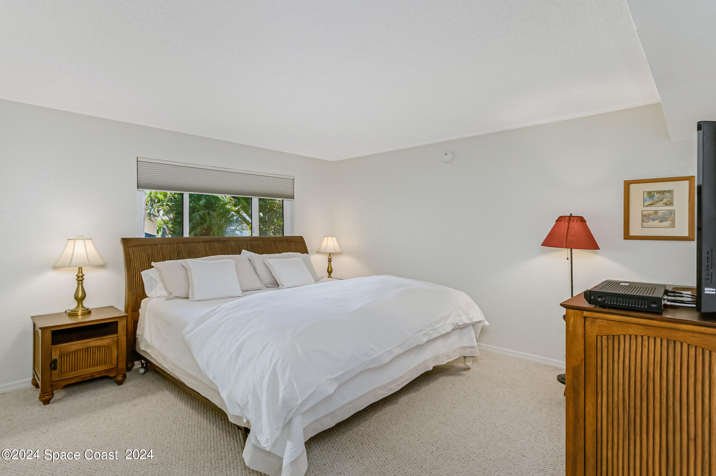 5050 Ocean Beach Boulevard Cocoa Beach, FL 32931 - Photo 23 of 33 a bedroom with a bed and a lamp