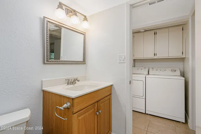 a utility room with sink washer and dryer