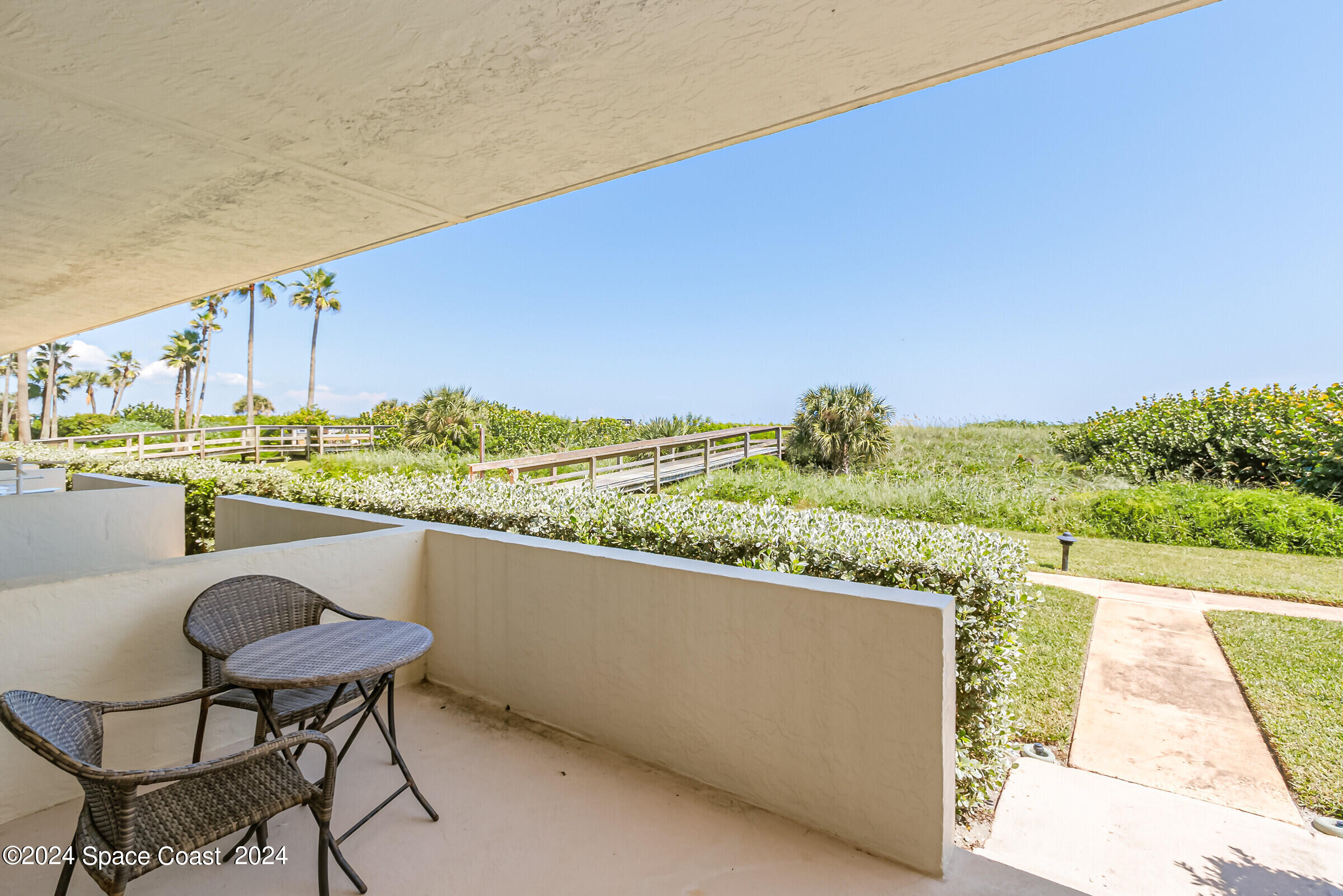 5050 Ocean Beach Boulevard Cocoa Beach, FL 32931 - Photo 26 of 33 a view of a chairs and table in patio