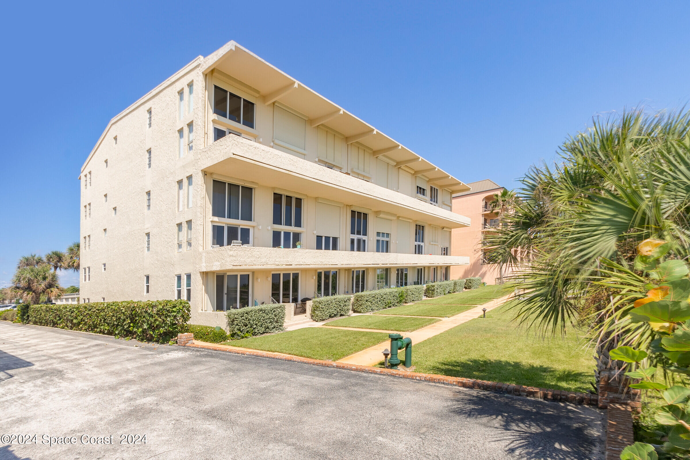 5050 Ocean Beach Boulevard Cocoa Beach, FL 32931 - Photo 27 of 33 a front view of a building with a garden