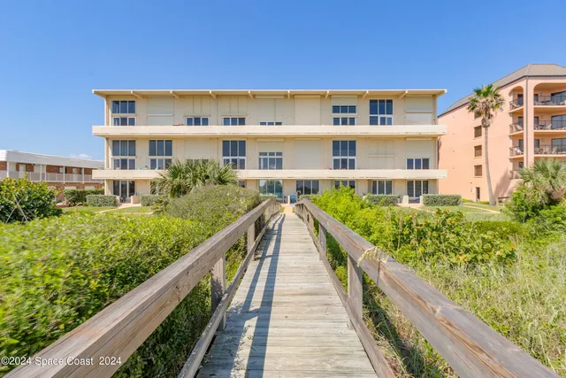 a view of a large building with a yard