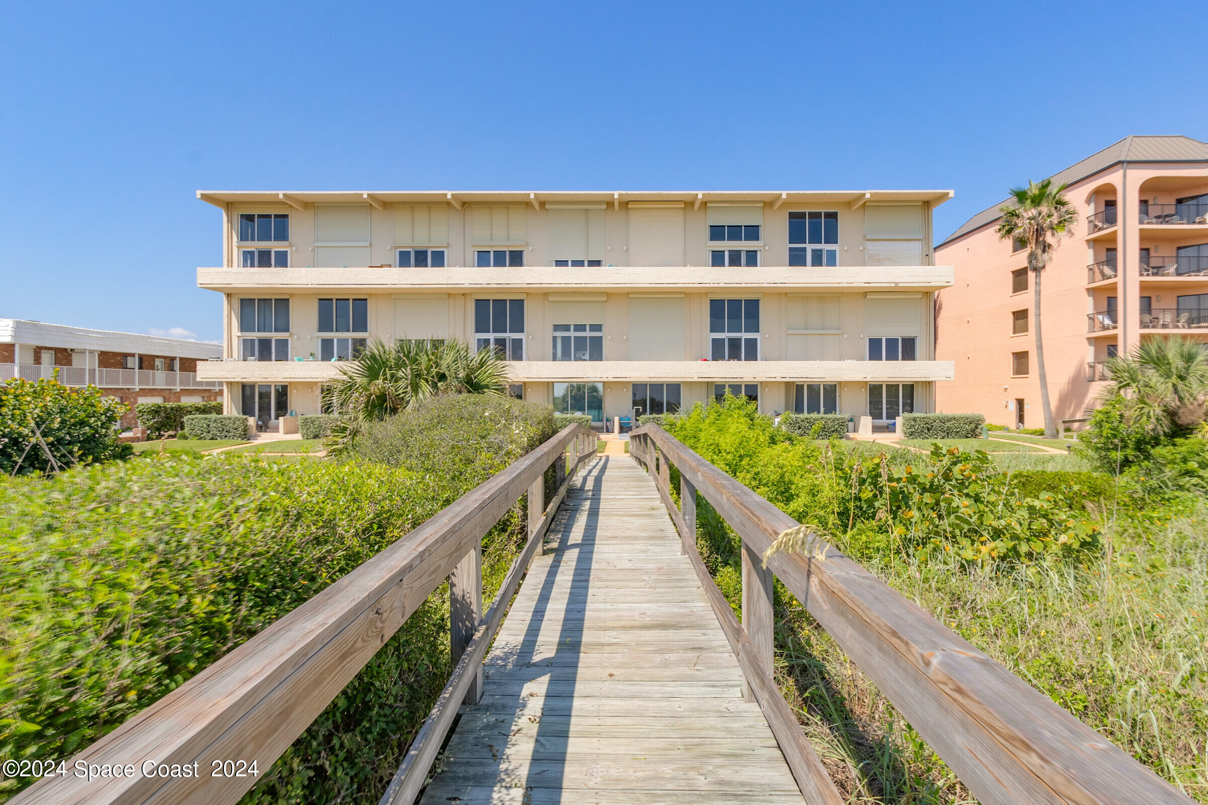 5050 Ocean Beach Boulevard Cocoa Beach, FL 32931 - Photo 29 of 33 a view of a large building with a yard