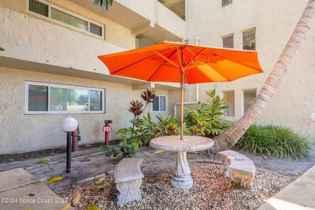 a view of a chair and table in the patio