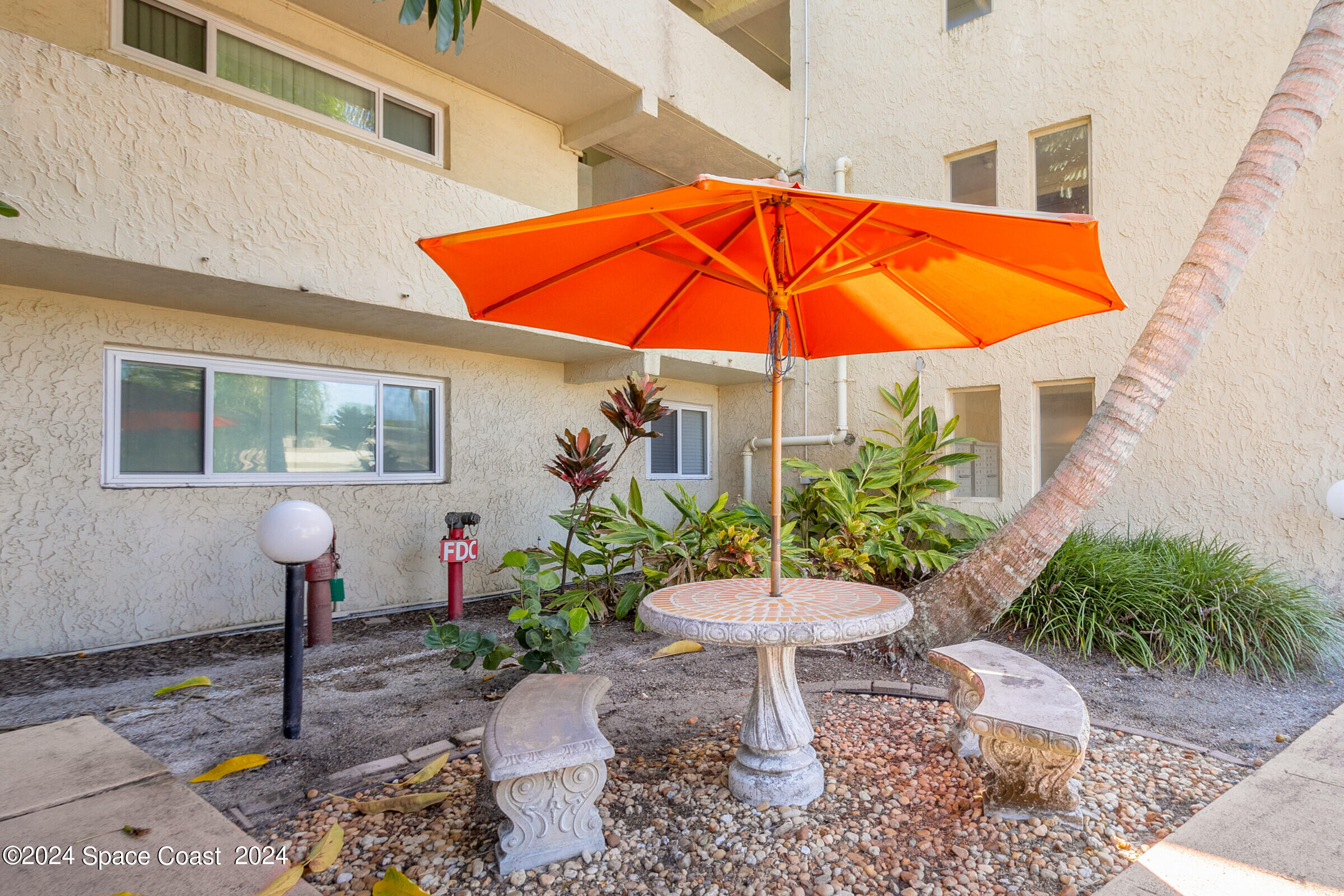 5050 Ocean Beach Boulevard Cocoa Beach, FL 32931 - Photo 4 of 33 a view of a chair and table in the patio