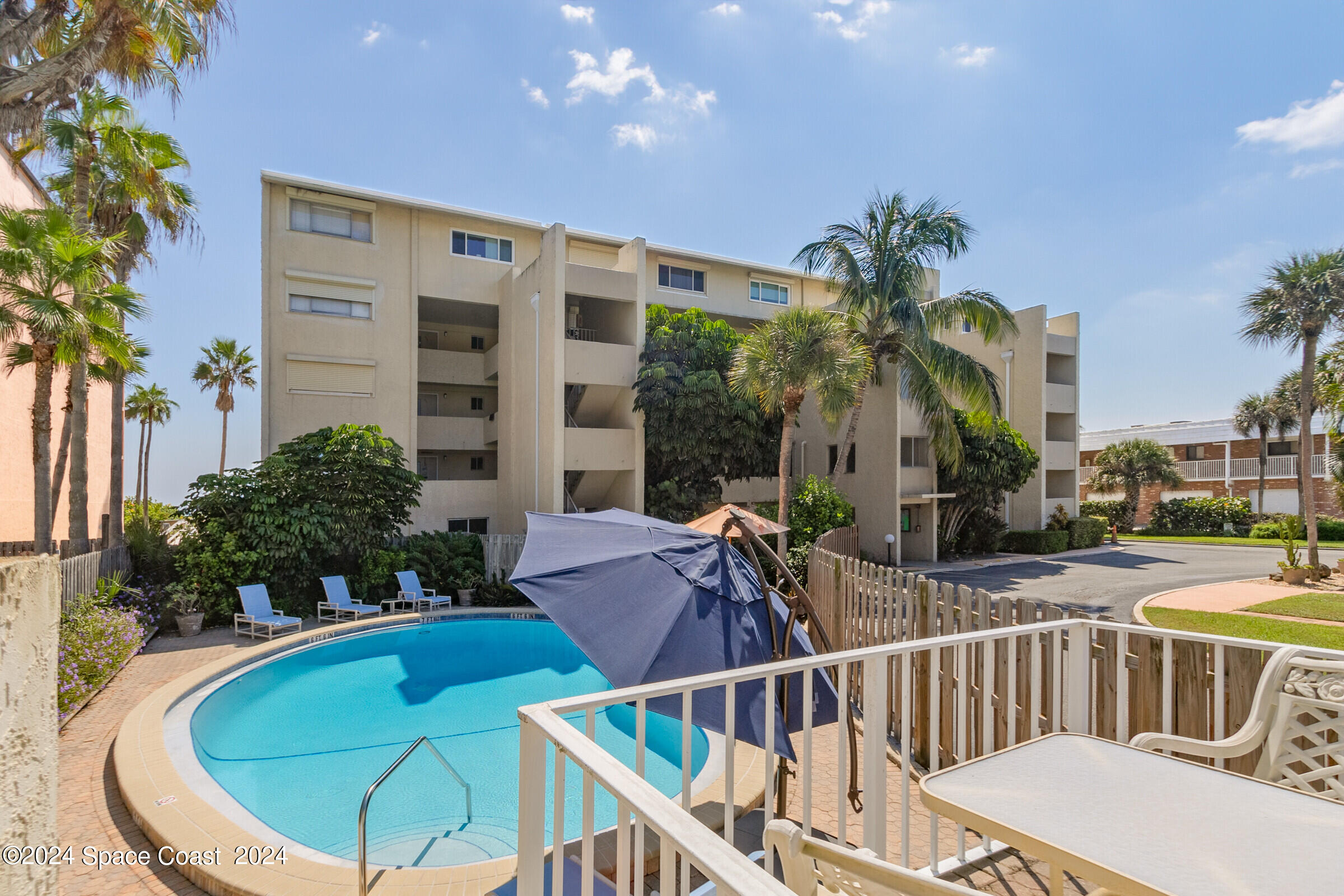 5050 Ocean Beach Boulevard Cocoa Beach, FL 32931 - Photo 5 of 33 a view of balcony with furniture and potted plants