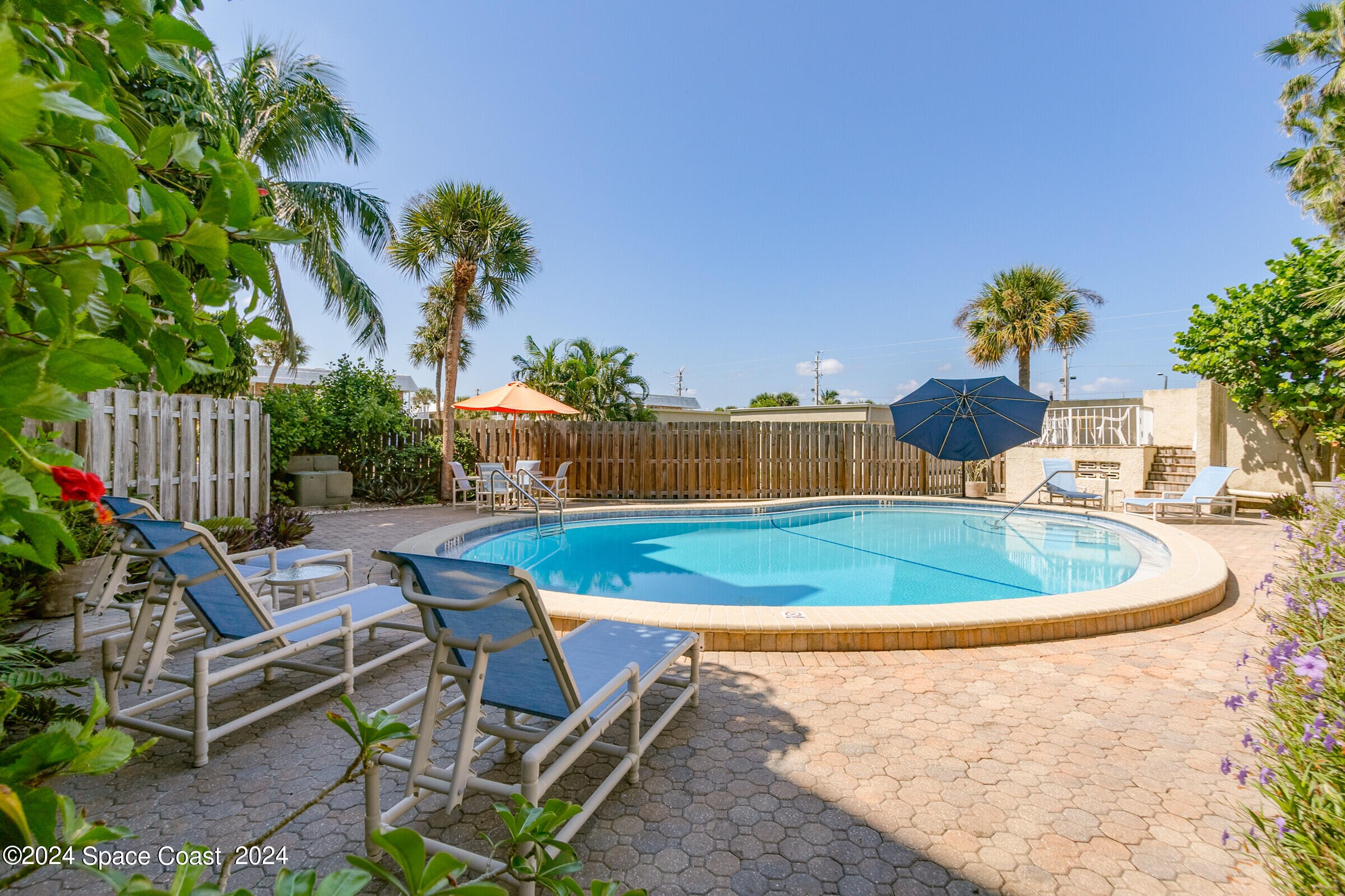 5050 Ocean Beach Boulevard Cocoa Beach, FL 32931 - Photo 6 of 33 a terrace with outdoor seating and covered with trees