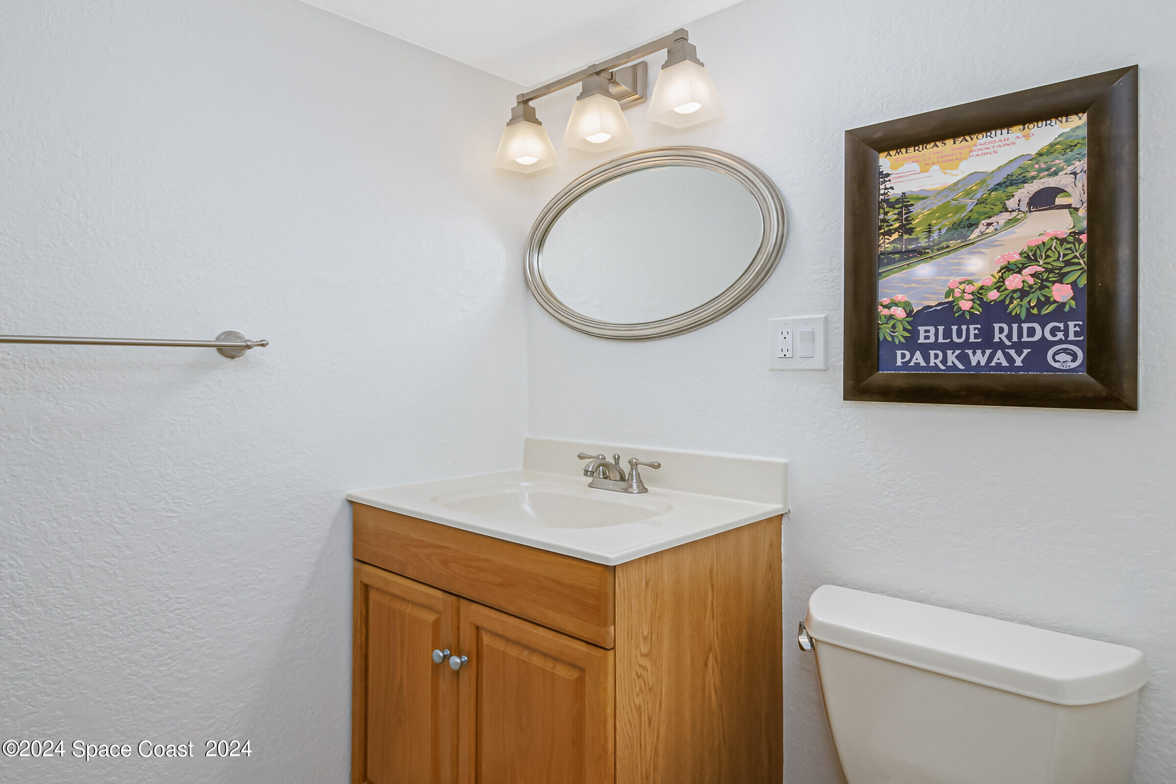 5050 Ocean Beach Boulevard Cocoa Beach, FL 32931 - Photo 10 of 33 a bathroom with a toilet a sink and a mirror