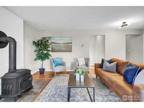 a living room with furniture potted plant and a lamp