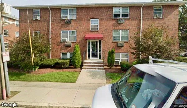 a front view of a house with yard and green space