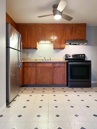 a kitchen with stainless steel appliances granite countertop a stove a refrigerator and a sink