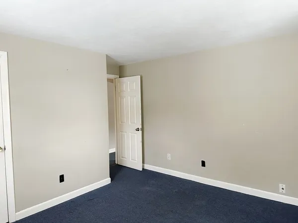 an empty room with closet area
