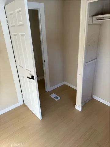 an empty room with a wooden door