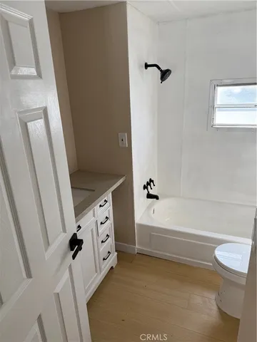 a bathroom with a bathtub a toilet and a sink