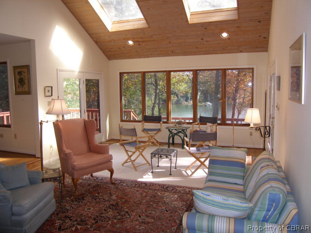 879 West Point Road Lancaster, VA 22503 - Photo 3 of 38 a living room with furniture and a large window