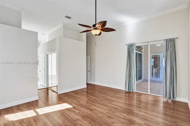 a view of empty room with wooden floor