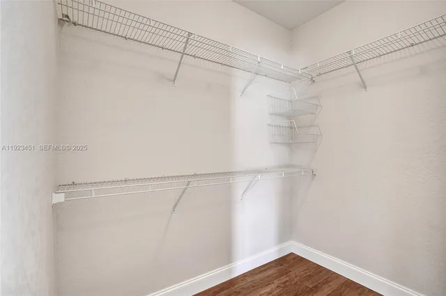 a large white bathroom with a sink a mirror and a bathtub