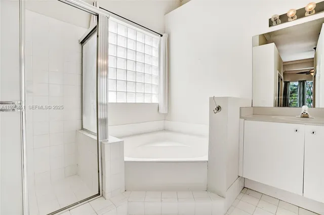 a bathroom with a tub shower and sink