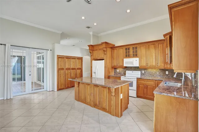 a kitchen with granite countertop a stove and a sink