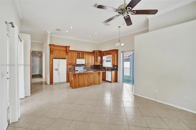 a large kitchen with a large window and stainless steel appliances