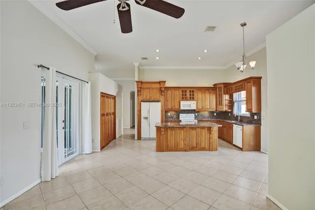 a kitchen with stainless steel appliances granite countertop a refrigerator and a sink