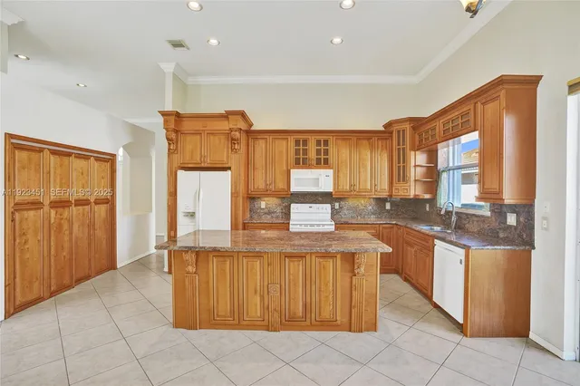 an empty room with closet and a chandelier fan