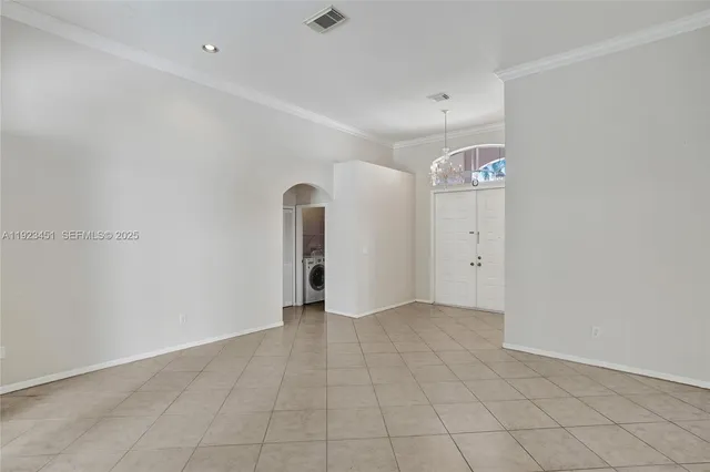 an empty room with entrance and windows