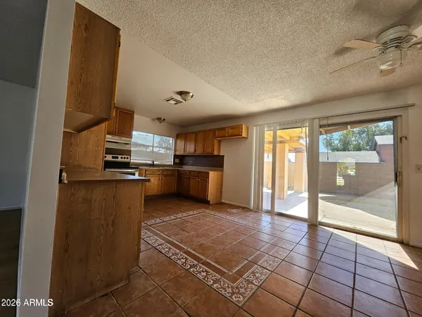 a kitchen with stainless steel appliances granite countertop a refrigerator and a stove top oven