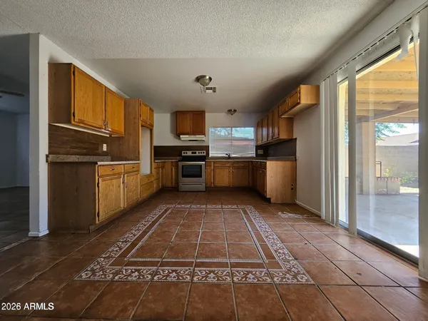 a kitchen with stainless steel appliances granite countertop a refrigerator stove and sink