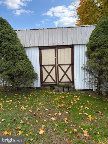 a view of a house with a yard and tree