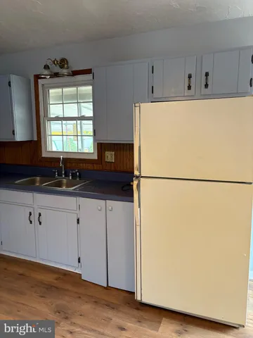 a view of an empty room and wooden floor