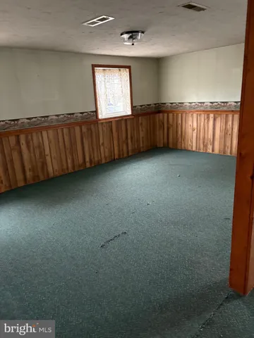 a view of an empty room with a fireplace