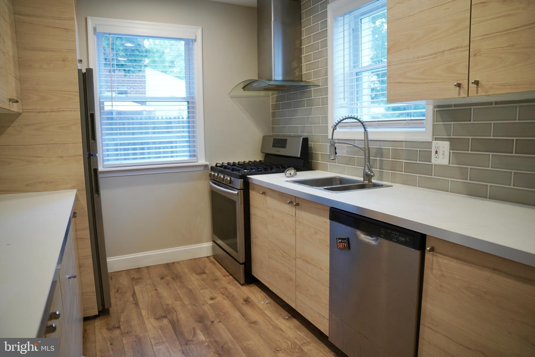 2230 Houston Street Suitland, MD 20746 - Photo 11 of 18 a kitchen with a sink stove and cabinets