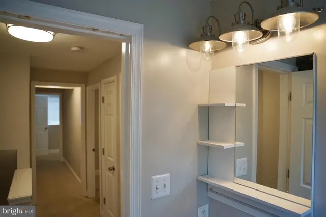 a bathroom with a mirror and a shower