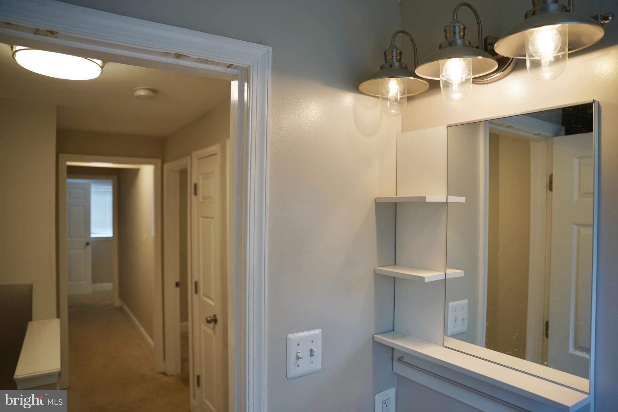 2230 Houston Street Suitland, MD 20746 - Photo 12 of 18 a bathroom with a mirror and a shower
