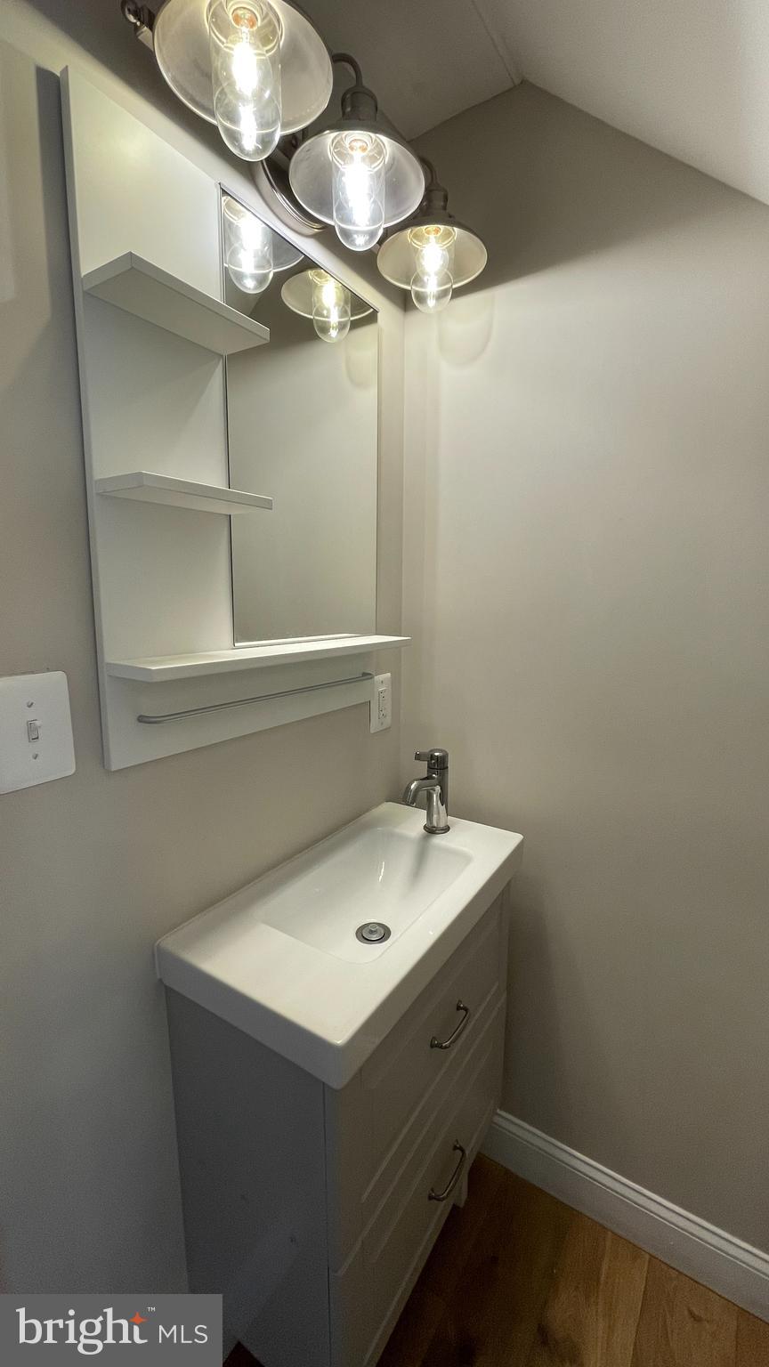 2230 Houston Street Suitland, MD 20746 - Photo 13 of 18 a bathroom with a sink and a mirror