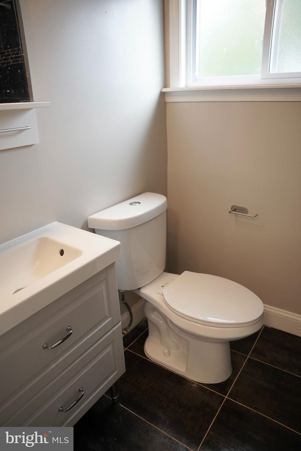 2230 Houston Street Suitland, MD 20746 - Photo 15 of 18 a white toilet sitting next to a window