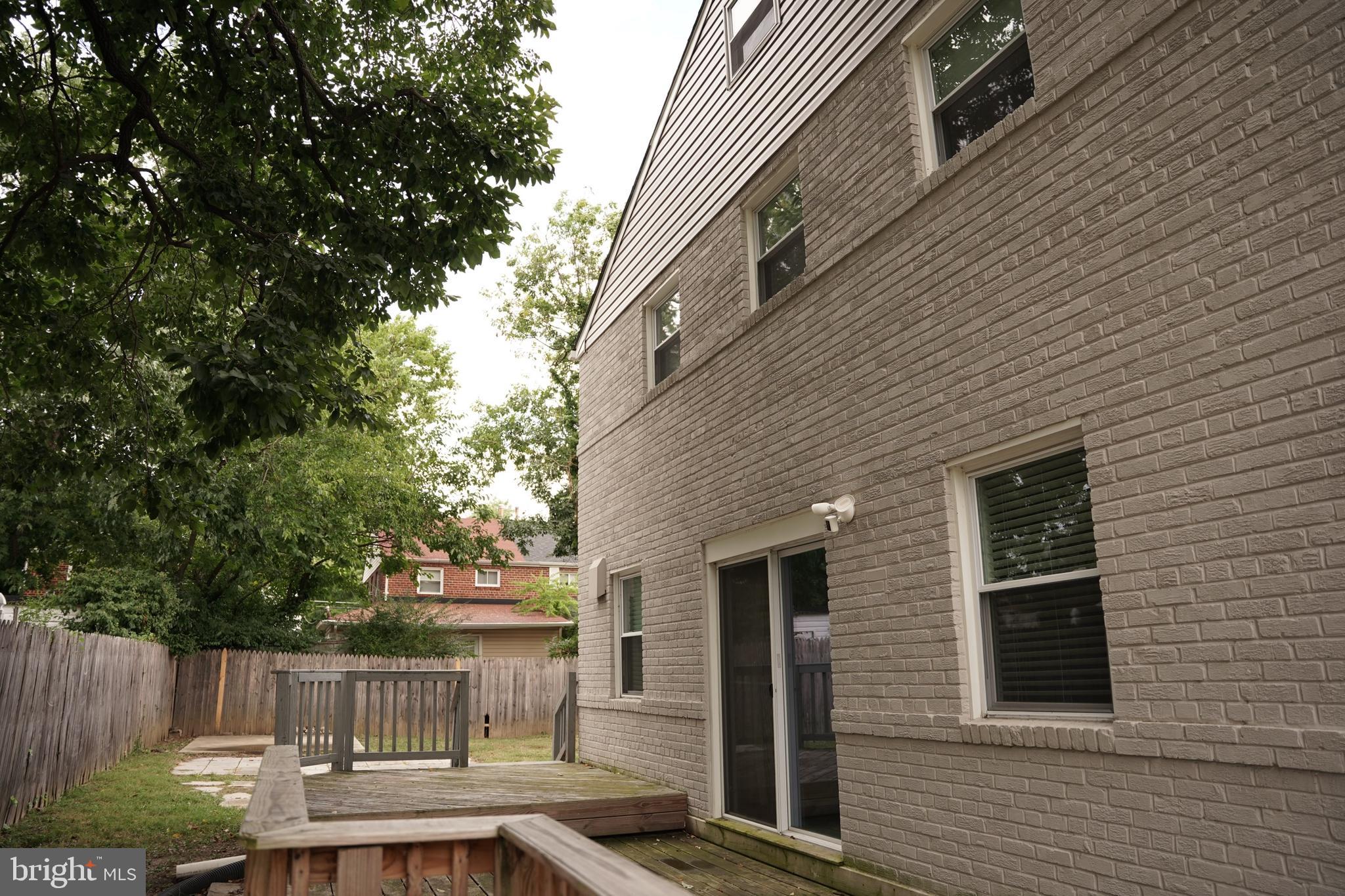 2230 Houston Street Suitland, MD 20746 - Photo 2 of 18 a view of backyard with barbeque grill and wooden fence
