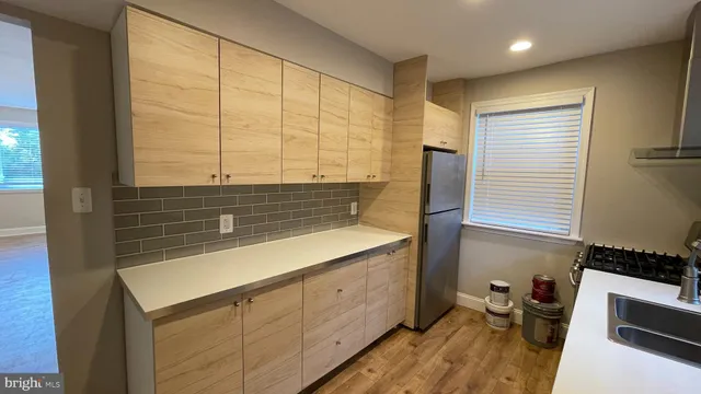 a kitchen with a sink and a stove top oven