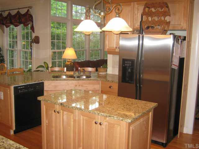 5201 Indigo Moon Way Raleigh, NC 27613 - Photo 6 of 12 Another shot of the huge kitchen! Hardwoods and custom light fixtures also! Kitchen