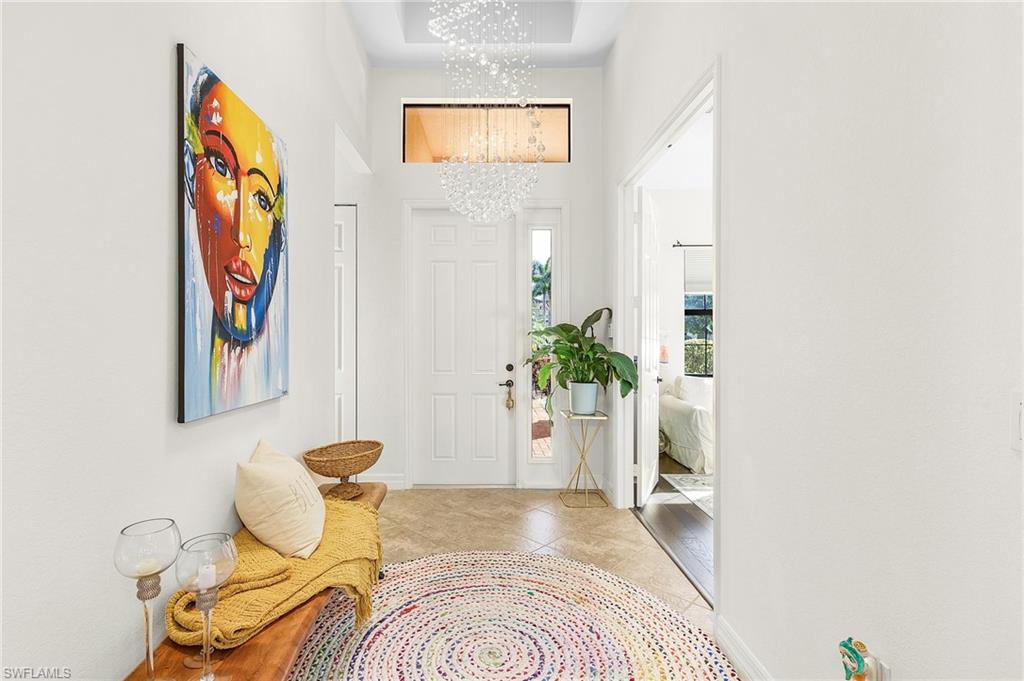 a spacious bedroom with a bed and a potted plant