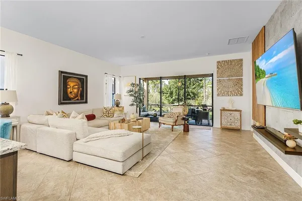 a living room with furniture and a floor to ceiling window